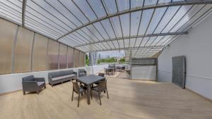a dining room with a table and chairs and a ceiling at We Are Hostel 2 in Póvoa de Varzim