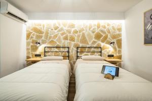 A bed or beds in a room at Mathraki Resort