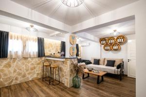 a living room with a couch and a table at Mathraki Resort in Gouvia