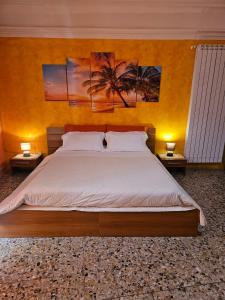a bedroom with a large bed with two night stands at B&B Al Borgo in Troina