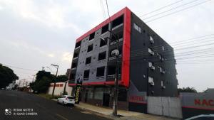 a building on a street with a car parked in front at hotel nacional palace in Foz do Iguaçu