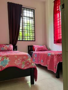 a bedroom with two beds and a window at AziziYati Muslem Homestay KLIA Sepang - SemiD House in Sepang