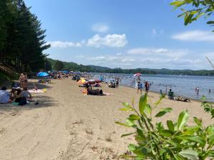 a group of people on a beach near the water at Auberge Hotel Spa Watel in Sainte-Agathe-des-Monts +37 photos