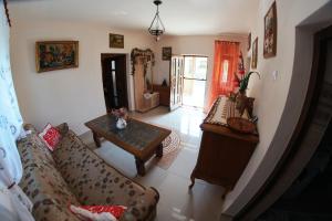 a living room with a couch and a table at Casa Ciobanca in Vadul lui Carol II