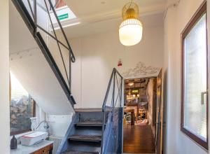 a staircase leading up to a room with a window at Historisches Stellwerk mit Garten in bester Innenstadtlage & Boxspringbetten nahe der Schweizer Grenze in Lörrach