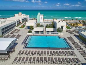 an aerial view of a resort with a swimming pool and the ocean at Hollywood Studios Condo Costa in Hollywood