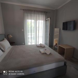 Ένα ή περισσότερα κρεβάτια σε δωμάτιο στο Nafsika