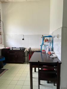 a kitchen with a table and a counter top at AziziYati Muslem Homestay KLIA Sepang - SemiD House in Sepang