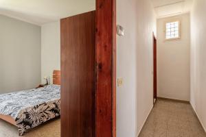 a bedroom with a wooden door leading to a bed at Apartments Volpino - Affitti Brevi Italia in Lucca