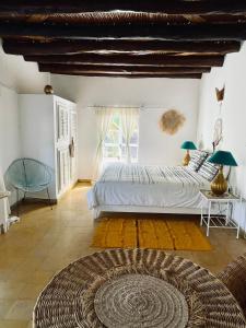 a bedroom with a large bed and a large window at Out of Medina in Essaouira