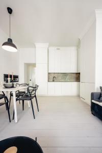 Apartamenty Woźna 14a, 2 rooms, self check in 24h في بوزنان: غرفة معيشة بيضاء مع طاولة وكراسي +25 صورة