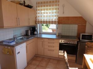 a kitchen with a sink and a stove at Loft Sierksdorf in Sierksdorf