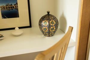 a vase sitting on a shelf next to a stair case at Countryside Villa with Nature & Pool - 'Casa dos Vasconcelos' in Chaves