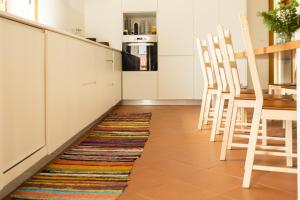 a kitchen with a colorful rug on the floor at Countryside Villa with Nature & Pool - 'Casa dos Vasconcelos' in Chaves