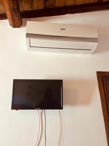 a flat screen tv hanging from a ceiling at Albergo Dal Fata in Gambassi Terme
