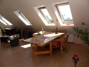 a room with a wooden table and some windows at Loft Sierksdorf in Sierksdorf