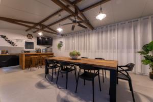 a dining room with a wooden table and chairs at Villa Bepo in Plano