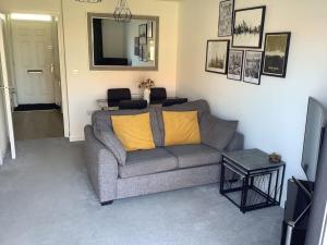 a living room with a couch and a mirror at Entire 2 bedroom house in Tamworth in Tamworth