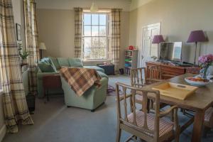 a living room with a couch and a table at John McDouall Stuart View in Dysart