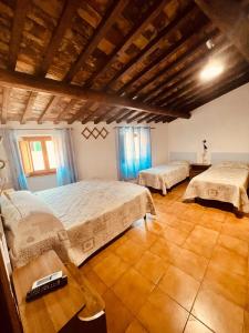 a large bedroom with two beds and a table at Albergo Dal Fata in Gambassi Terme