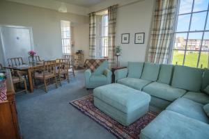 a living room with a couch and a table and chairs at John McDouall Stuart View in Dysart