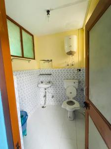 a bathroom with a toilet and a sink at hotel new sahil in Srinagar