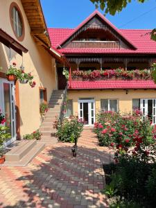 a house with flowers on the side of it at Pensiunea Alina in Agapia