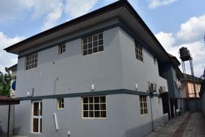 a white building with a black roof at Rehoboth Homes in Port Harcourt