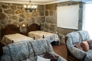 a living room with a stone wall at Leira da Cruz Grande in Castelo de Paiva +66 photos