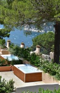 a hot tub with a view of the water at Villa Lia Hotel Capri in Capri