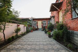 a walkway between two buildings with a brick wall at Guesthouse Old Town in Kutaisi