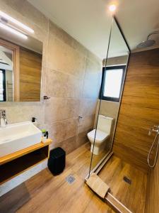a bathroom with a shower and a sink and a toilet at athilia in Nikiana +127 photos