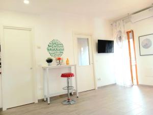 a red stool in a room with a white wall at Casa Vacanze MARE BOOM in Martinsicuro