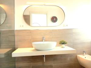 a bathroom with a white sink and a mirror at Casa Vacanze MARE BOOM in Martinsicuro