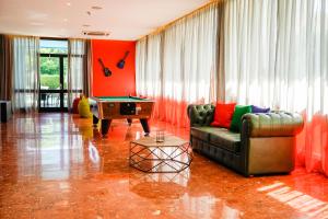 a living room with a couch and a pool table at Lloret Vibe Affiliated by FERGUS in Lloret de Mar