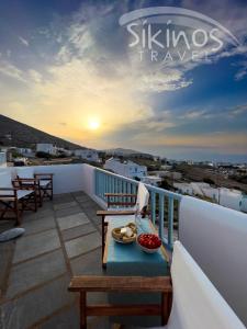 a balcony with a table with a bowl of fruit on it at Traditional Maisonette with picturesque Chora View in Chora Folegandros