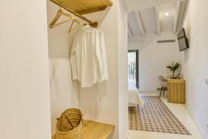 a room with white walls and a hallway with a clothes rack at Mas Cusi in Palau-Saverdera +163 photos