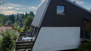 a house with a balcony with a table on it at Freyunger Berghaus in Freyung