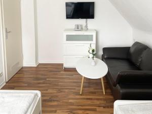 a living room with a couch and a table at Cozy Workers Apartment in Siegburg in Siegburg