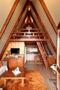 a room with a loft with a spiral staircase at The Rancho Relaxo in Zítsa