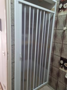 a sliding glass door in a room with a shower at Casa Azzurra in Villaggio Azzurro +9 photos