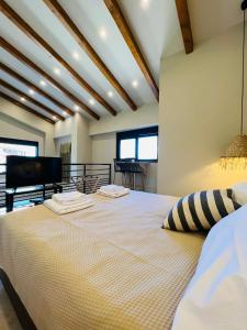 a large bed with two pillows on it in a room at athilia in Nikiana