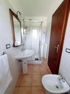 a bathroom with a sink and a shower and a toilet at Albergo del Sangro in Pescasseroli