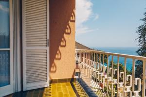 een balkon met stoelen en uitzicht op de oceaan bij 114b - Casa Luna Vista Mare, 5 minuti dalla spiaggia a piedi - PARCHEGGIO PRIVATO GRATIS INCLUSO in Ospedaletti