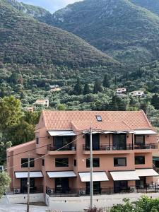 an apartment building with a view of a mountain at athilia in Nikiana