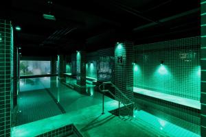 a swimming pool with blue lights in a building at Promenade Link Stay Barra da Tijuca in Rio de Janeiro