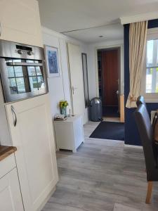 a living room with a hallway with a door and a table at NV 206 - Beach Resort Nieuwvliet Bad in Nieuwvliet