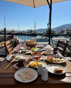 a wooden table with plates of food on it at Caglayan pansiyon in Bodrum City