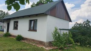 a white house with a black roof at Domek na wsi 