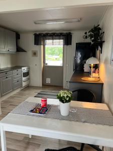 a kitchen with a white table in a room at Vänersborg in Vänersborg